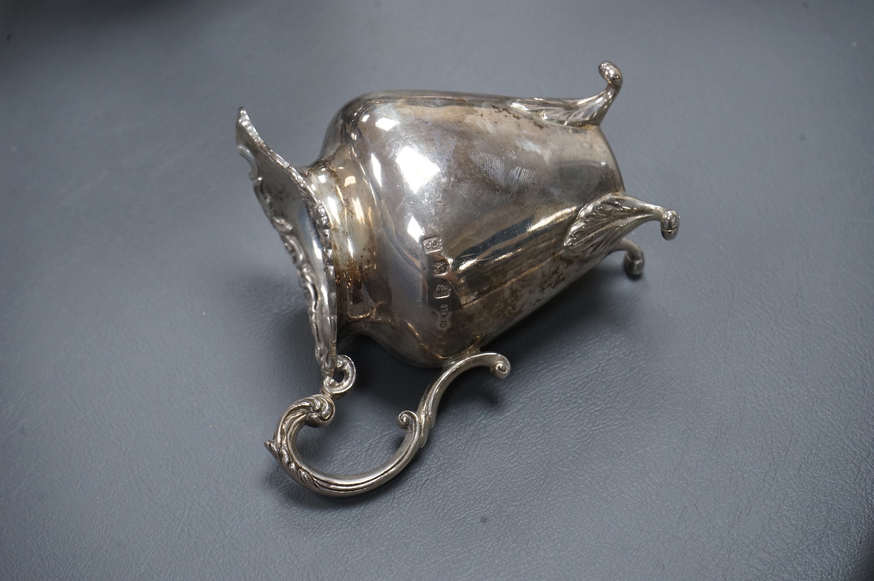 An Edwardian Scottish silver three piece oval tea set by Weir & Sons, Glasgow, 1901, gross 25.5oz, with foliate borders.